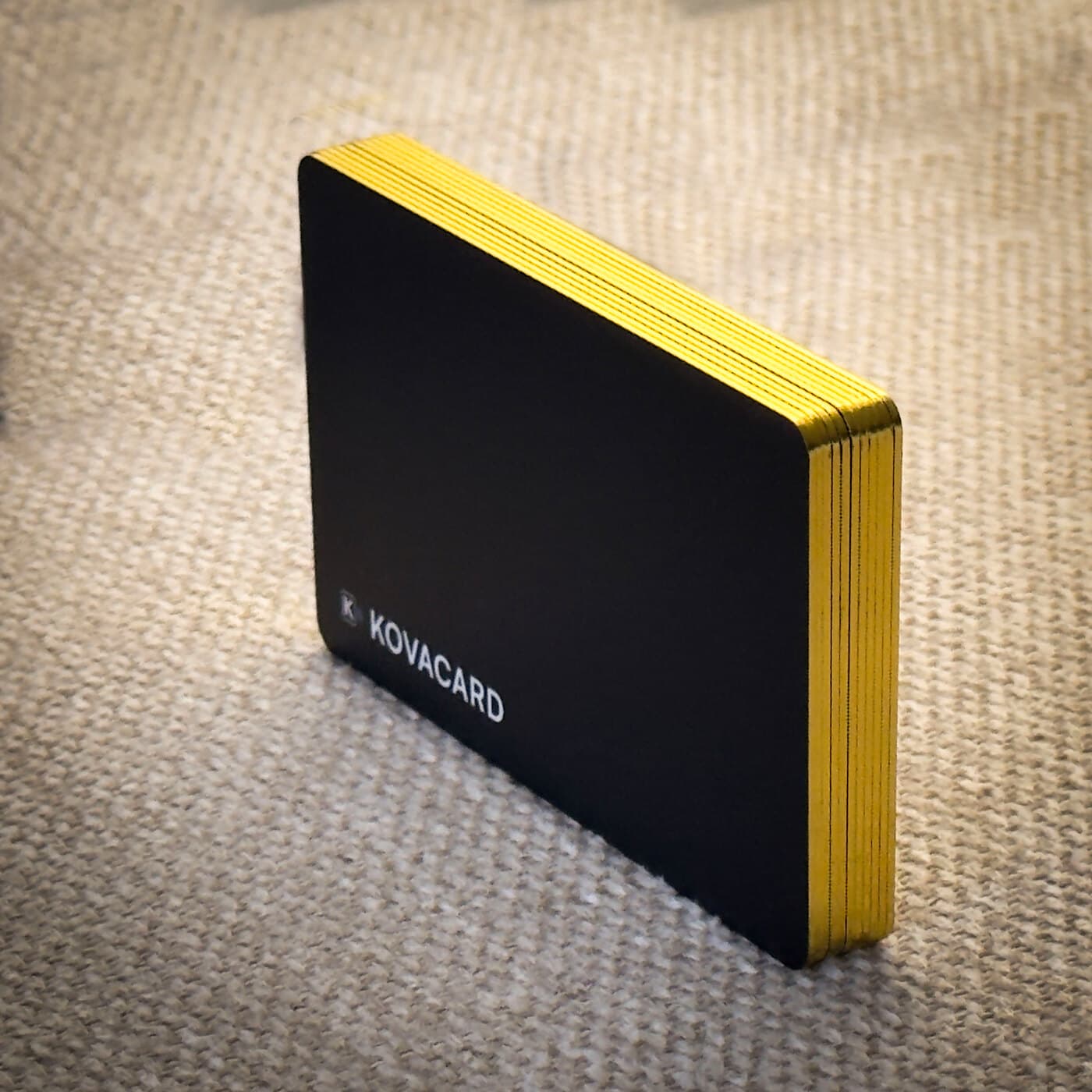 The gold foil edge wrapping a matte black card, stood on its side